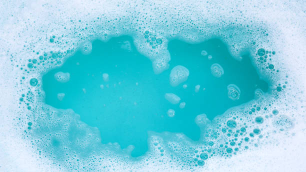 istock Detergent foam bubble on water. Blue background, Soap sud 2111085404