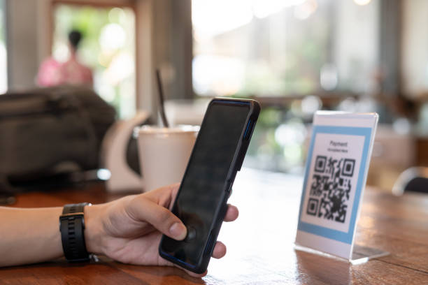 istock man use smartphone to scan QR code for order menu in cafe restaurant with a digital delivery. Choose menu and order accumulate discount. E wallet, technology, pay online, credit card, bank app. 2111110244
