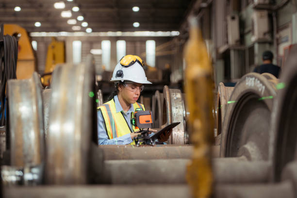 istock Railway technician in uniform and helmet inspect the train wheels 2111123710