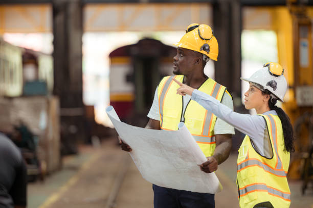 istock Railway technicians and engineers, Inspect the trains in train repair station before being used to drag train cars to receive or transport goods and people. 2111134489