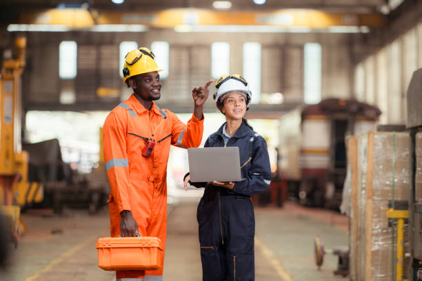 istock Railway technicians and engineers, Inspect the trains in train repair station before being used to drag train cars to receive or transport goods and people. 2111145228