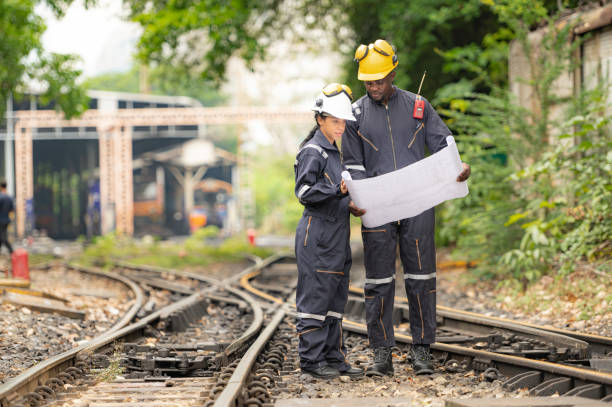 istock Railway technicians and engineers, Working on the train tracks at train station 2111148323