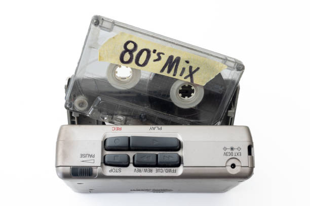 Holding a 80's mix cassette tape with walkman.