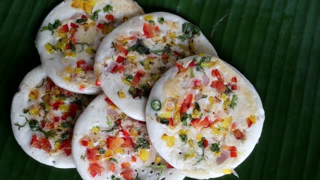 Serving colorful South Indian Uttapam with Coconut, green chili chutney
