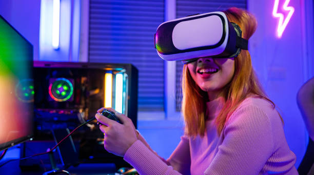 istock Gamer in VR headset glasses exploring metaverse play video game online with joystick 2111200443