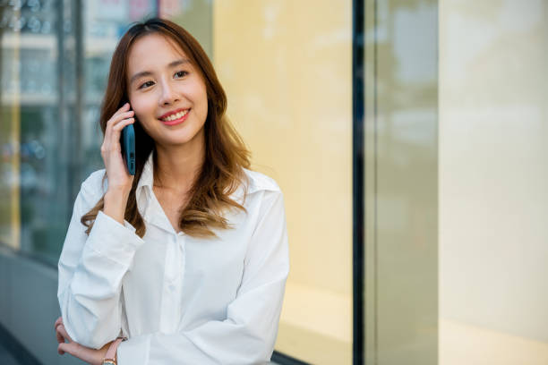 istock Smiling woman using mobile phone. 2111200972