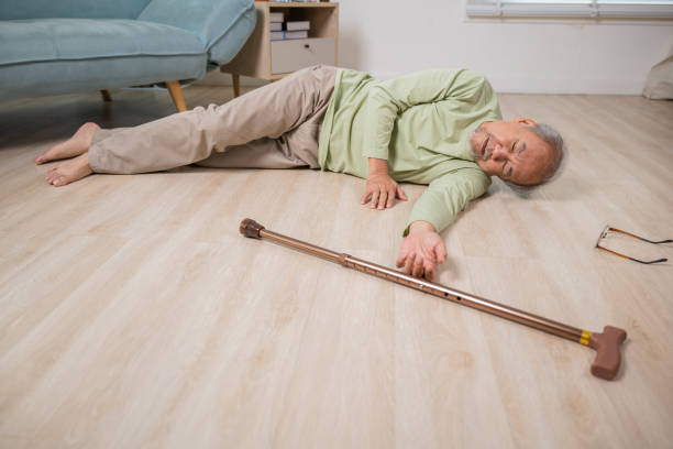 istock Older senior man headache lying on the floor after falling 2111200983