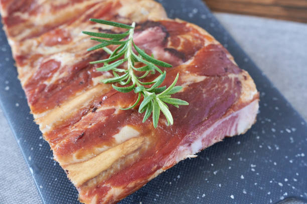 istock Smoked ribs with rosemary on a black cutting board 2111302465