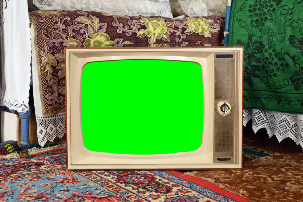 istock An old vintage TV with a green screen in a rustic interior. 2111307915
