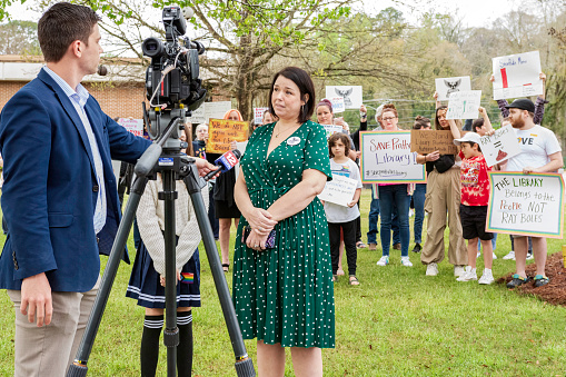 Prattville, Alabama, USA-March 16, 2024: Amber Frey with Read Freely Alabama is interviewed by WSFA TV12 during a public protest in front of the Autauga Prattville Public Library in opposition to the actions of the library board to fire the library director and several staff.