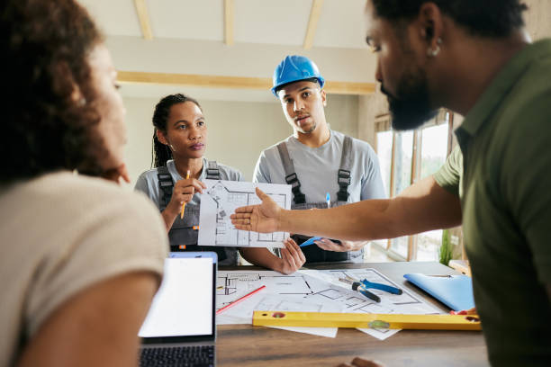 istock Manual workers talking to their customers about housing plans. 2111361984