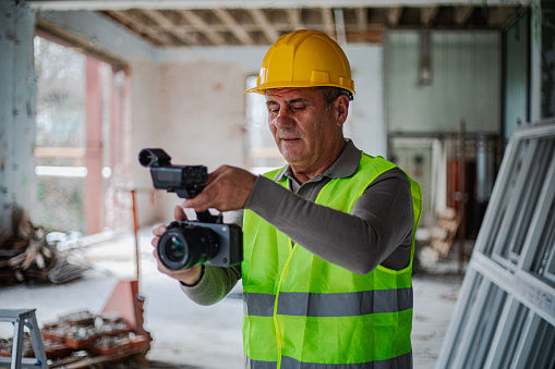 Photographer with a camera at the construction site