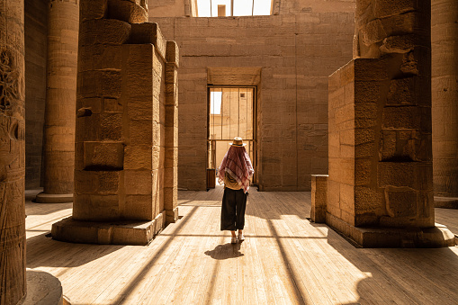 Woman walking in Temple of Philae aka Temple of Isis in Aswan Egypt,Agilkia Island