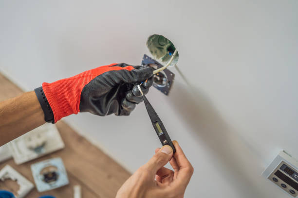 istock Master electrician installs a socket in the house 2111380273