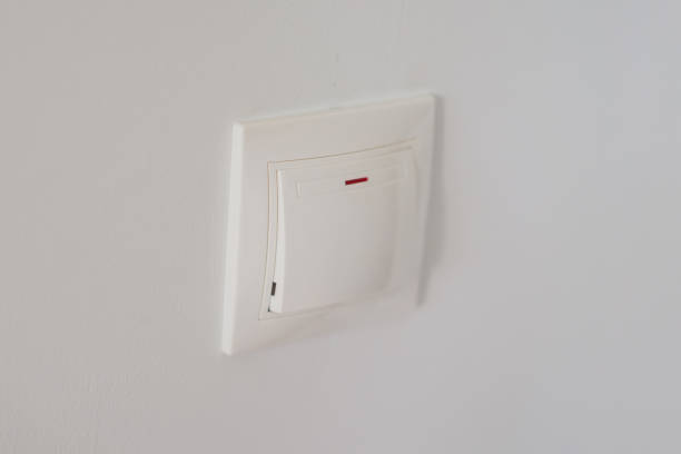 istock Master electrician installs a socket in the house 2111380280