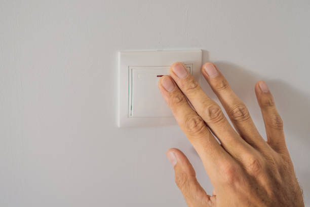 istock Master electrician installs a socket in the house 2111380282