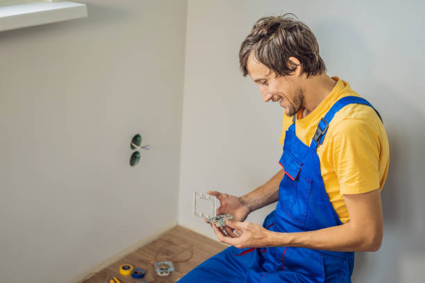 master electrician installs a socket in the house - mounted guard ストックフォトと画像