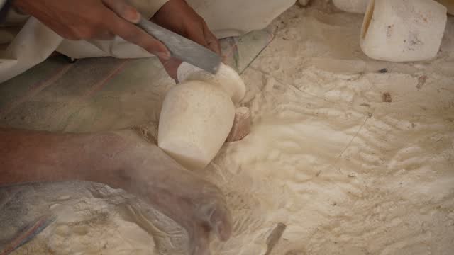 4K Video of  Egyptian craftsmen maintains the tradition of hand-carving alabaster an alabaster factory in Luxor, Egypt.