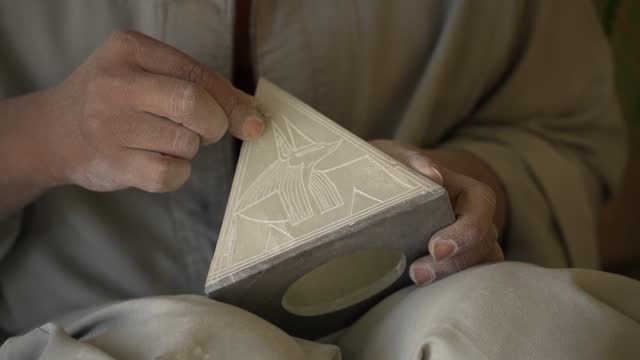 4K Video of  Egyptian craftsmen maintains the tradition of hand-carving alabaster an alabaster factory in Luxor, Egypt.