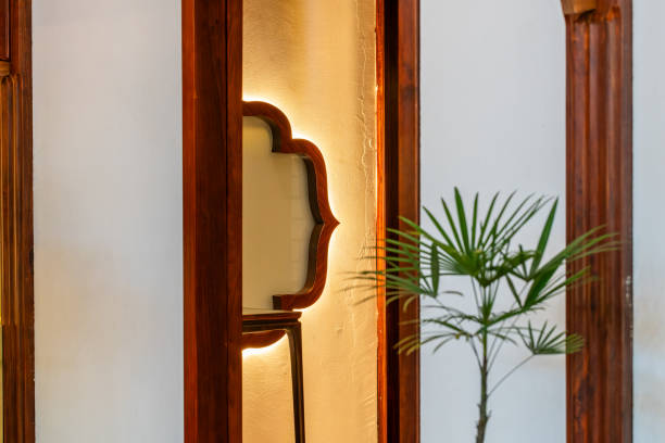 A close-up view of textured glass panels with an amber tint, framed by dark lines creating a geometric pattern. The warm lighting enhances the texture and color contrast, evoking a cozy and artistic ambiance. Suitable for design inspiration or artistic projects.