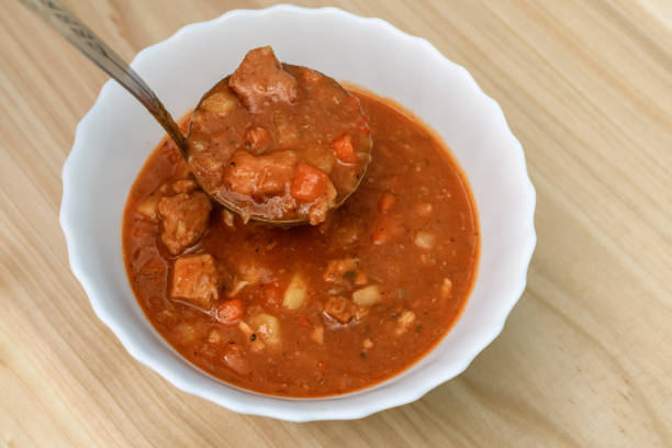 Ladle the meat stew with vegetables into a bowl