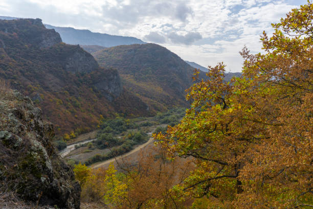 istock View of the mountains, river, fields and valley from the hill. 2111438505