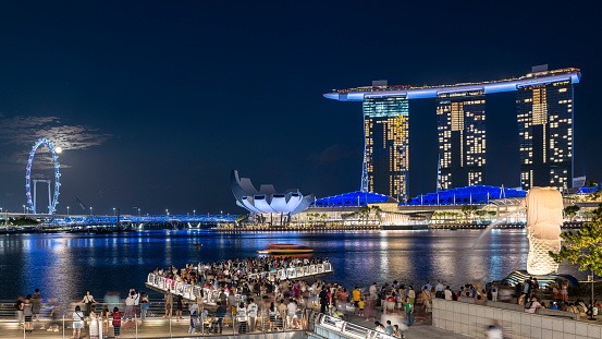 June 2020. Singapore. Panorama view of Marina bay Sands and the Marina district in Singapore at a late afternoon with the sunset light being reflected in the clouds. This photo was taken from the public path. The cloud formation is almost like the shape of a bird, eagle or a phoenix. Peaceful without any people, during the Singapore lockdown of 2020 because of the COVID-19 pandemic.