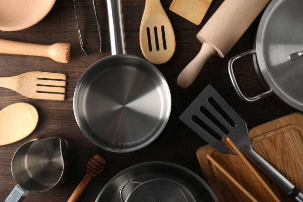 istock Different kitchen utensil on wooden background, top view 2111449166