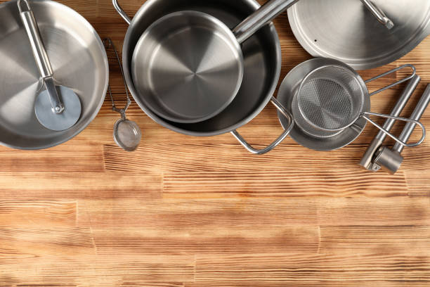 Kitchen utensil on wooden table, space for text.