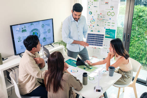istock Diversity team presentation new design solar cell panel renewable energy innovation at office 2111461335