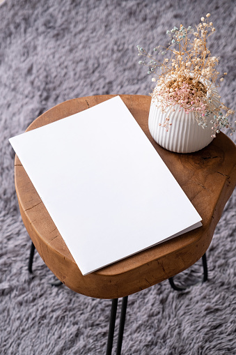 blank magazine mockup on coffee table with vase and grey rug. Template magazine cover