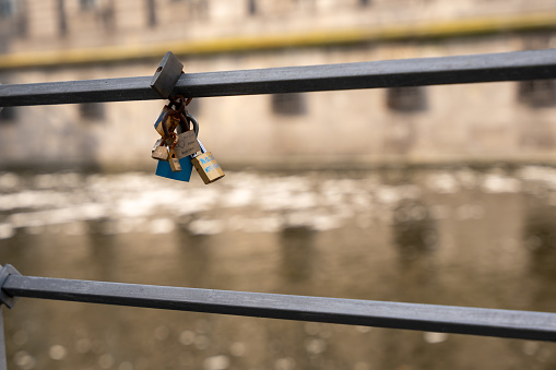 Love padlocks on the bridge Pont des Arts across river Seine in Paris, France.