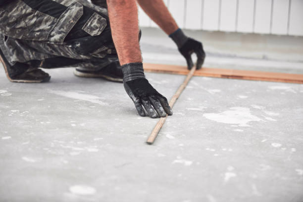 istock Professional handyman installing laminate flooring in a new apartment. 2111481230