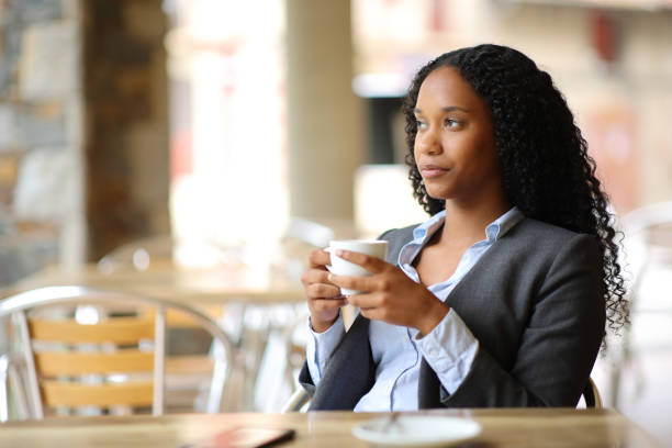 istock Relaxed black executive drinking coffee in a terrace 2111491294