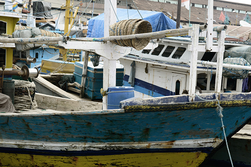 Colorful fishing vessels with equipment at harbor