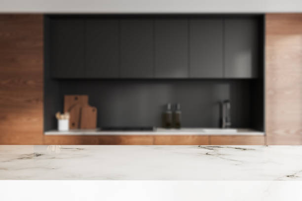 istock Marble countertop on background of kitchen interior with kitchenware. Mockup 2111501271
