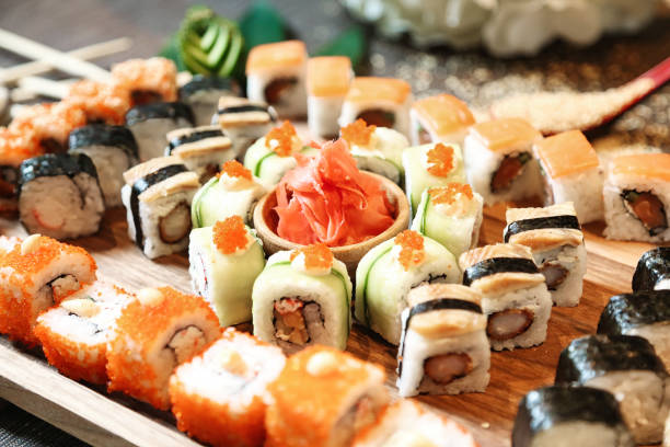 istock Wooden Tray Topped With Assorted Sushi Rolls 2111525499
