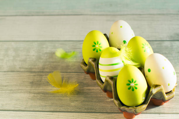 Easter concept with colored green eggs on wooden background. Top view.