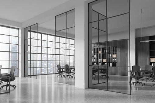 Corner view of office interior with glass meeting room, board and armchairs in row, grey concrete floor. Panoramic window on Singapore skyscrapers. 3D rendering