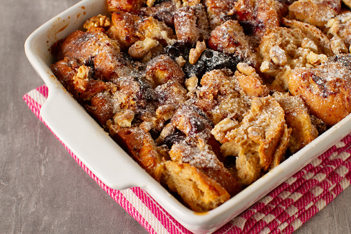 Leftovers bread pudding with nuts and berries on a table