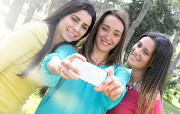 istock Girlfriends having selfie in the park 2111530782