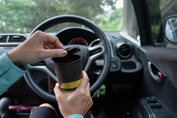 istock Unrecognizable Woman Drinking Coffee In the Car 2111533381