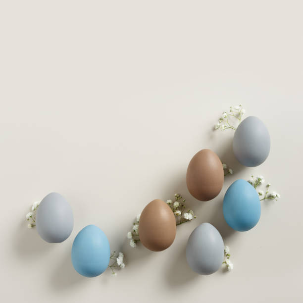 istock Pastel Easter Eggs as minimal pattern with white blooming Flowers on beige color, top view colorful chicken egg. Easter celebration concept. Festive food, still life holiday, aesthetic flat lay 2111537111