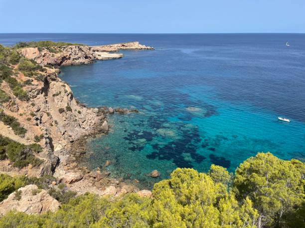 istock Sant Joan de Labritja beach in Ibiza (Spain). Turquoise waters in hidden bay. 2111551290