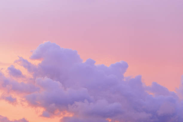 istock Pastel Sunset, violet fluffy clouds on pink peach colored sky, dreamy cloudscape pastel tones, surreal dreamscape at sunset, soft vivid colorful heaven as background, wallpaper, backdrop 2111558144