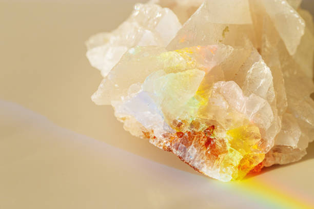 istock Quartz Prism's Rainbow Reflection at sunlight, close up of clear quartz crystal captures prismatic rainbow, natural facets and beauty of mineral. Minimal aesthetic nature pattern, beige pastel tone 2111558149