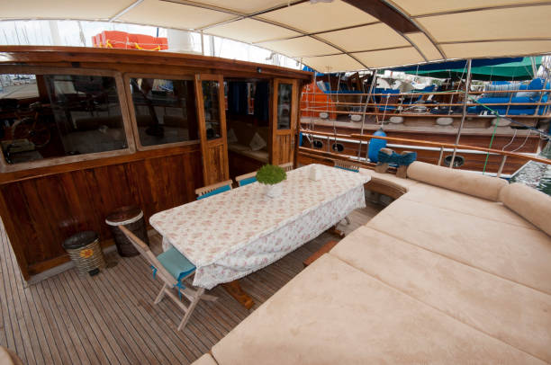 istock Wooden yacht deck with dining table 2111577713