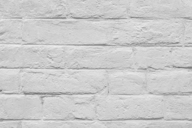 istock Stained old stucco white painted  brick wall background, aged masonry texture 2111578744