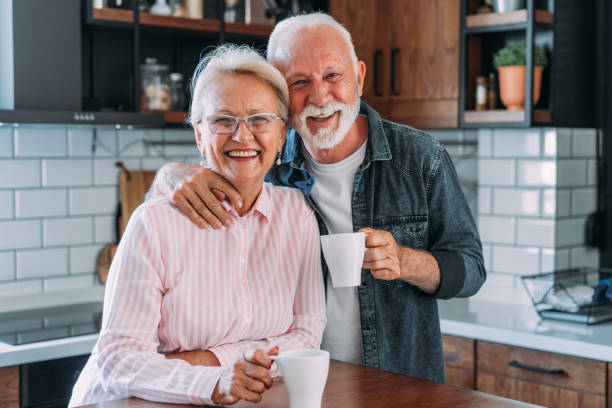 istock Lovely couple drinking coffee at home. 2111579268