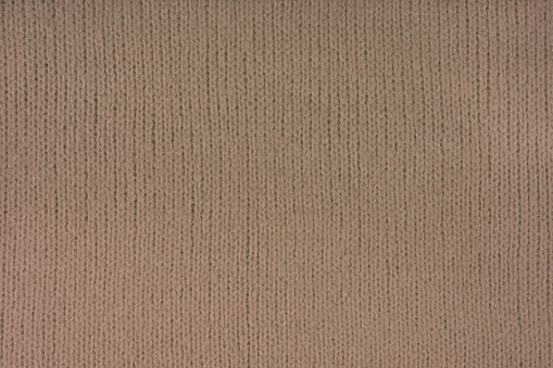 Brown knitted woolen jersey fabric, sweater, pullover texture background. Fabric abstract backdrop, cloth wallpaper